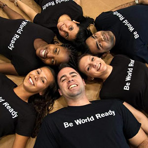 Group in circle with Be World Ready Shirts